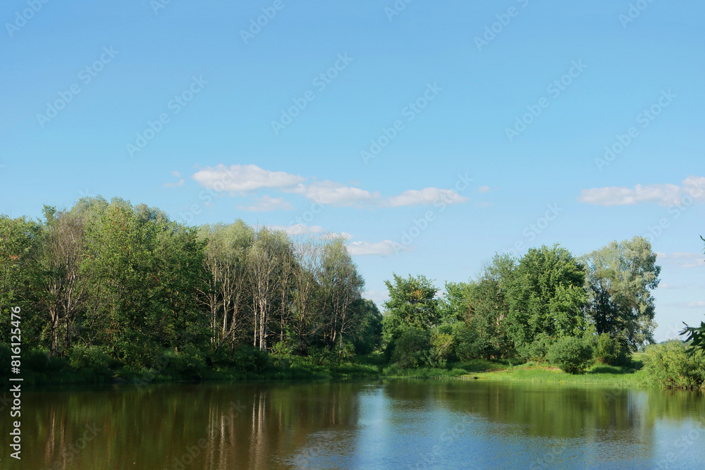 Landscape of a blue river with green forest.