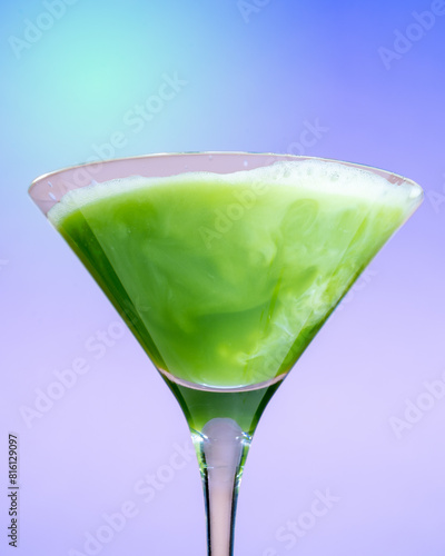 Matcha latte martini with a milk swirl on a gradient background