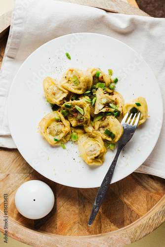 Mushroom tortellini with butter and herbs.