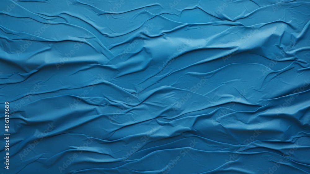 The image depicts undulating waves of a dynamic blue fabric texture ideal for backgrounds The image depicts undulating waves of a dynamic blue fabric texture ideal for backgrounds