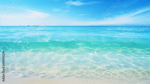 This image offers a broad view of a tranquil ocean expanse  with its clear turquoise waters stretching to the horizon