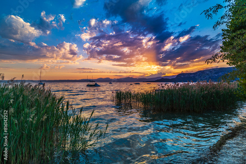 Bardolino Lake Garda Italy Sunset Water Boats and Reeds with Mountains and Clouds