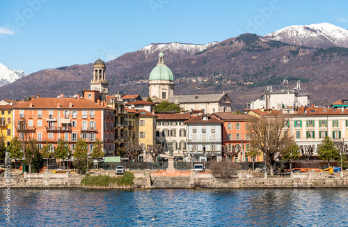 View of the Intra town from Lake Maggiore with snow capped mountains in the background, Verbania, Piedmont, Italy
