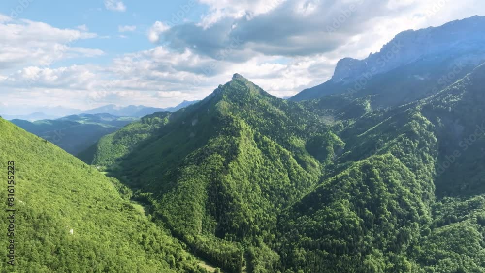 aerial view in spring of a small mountain covered with spade-shaped trees on the foothills of the Vercors in France aerial view in spring of a small mountain covered with spade-shaped trees on the foothills of the Vercors in France
