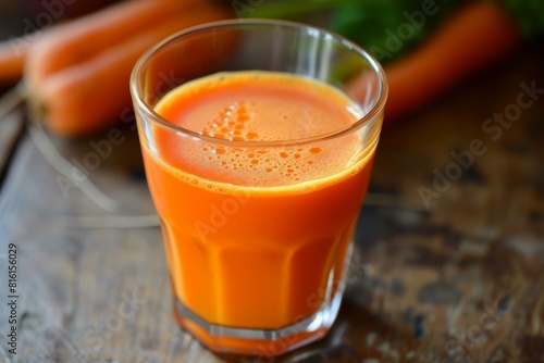 Wallpaper Mural Vibrant orange carrot juice served in a clear glass against a rustic backdrop Torontodigital.ca