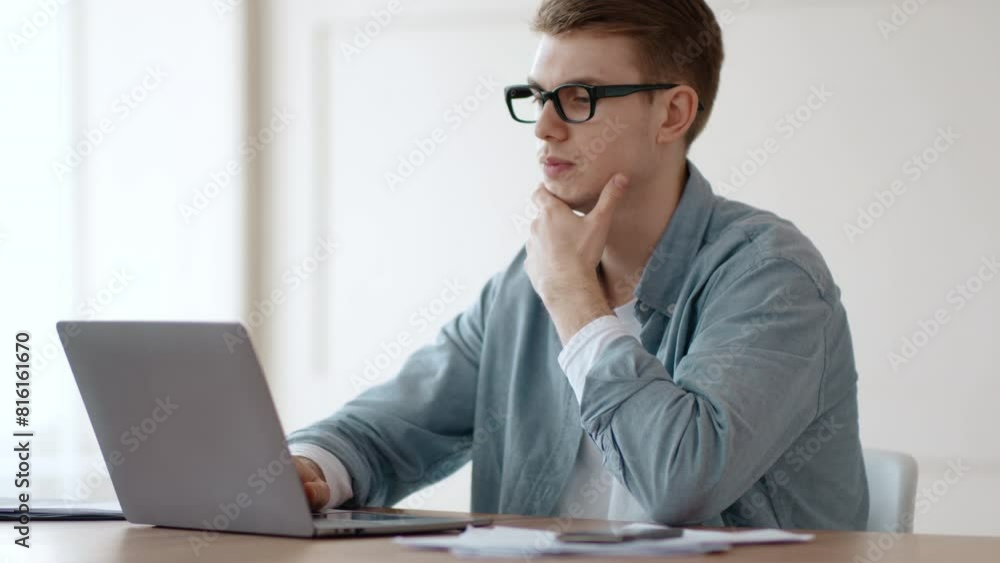 Remote business and problem solutions. Thoughtful guy working on laptop at home office Remote business and problem solutions. Thoughtful guy working on laptop at home office
