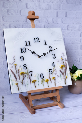 Clock. Clock hands. Clock on the table on the easel