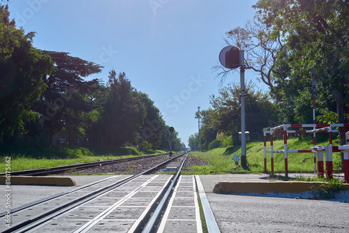 Fotografie Railroad Tracks at a Level Crossing: Railway Crossing with Train Tracks