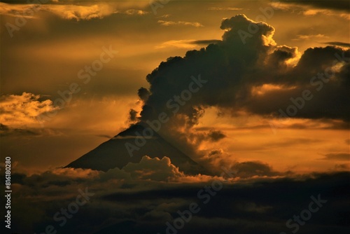 Activity of Sangay stratovolcano (5286 m) as observed at dusk from the Amazonian rainforest at the confluence of the rivers Rio Puyo and Pastaza (Amazonia, Ecuador) photo