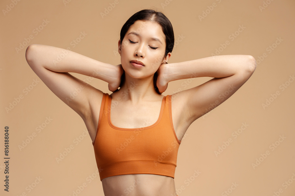 Sporty woman wearing sportswear stretching, training, doing exercises with closed eyes Sporty woman wearing sportswear stretching, training, doing exercises with closed eyes