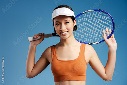Happy girl tennis player in sportswear holding tennis racket on isolated © Maria Vitkovska