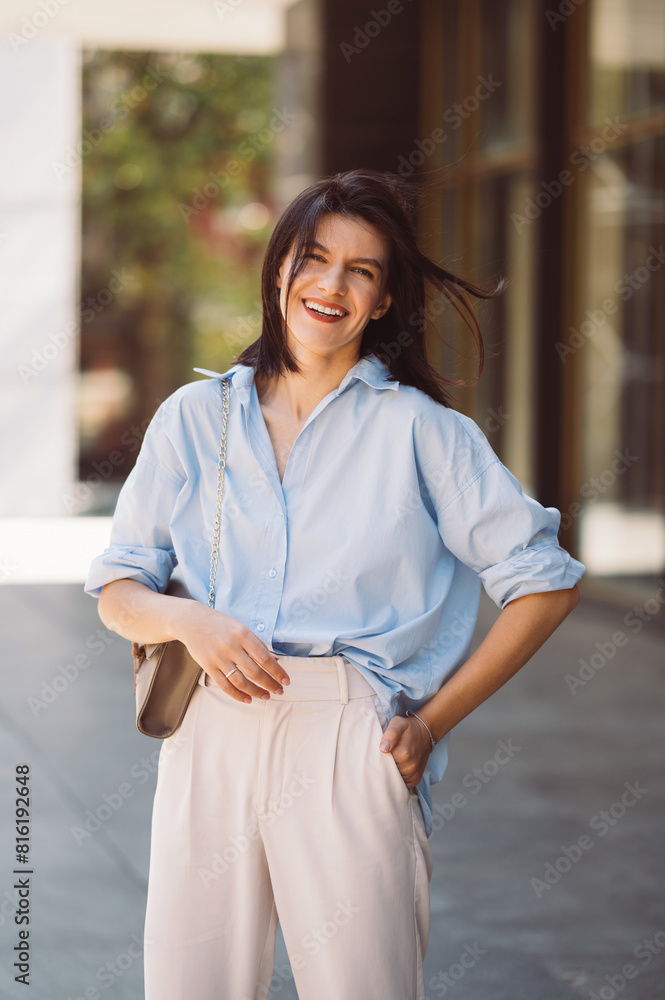 Young brunette woman is standing outdoors smiling and enjoying good life. Young brunette woman is standing outdoors smiling and enjoying good life.