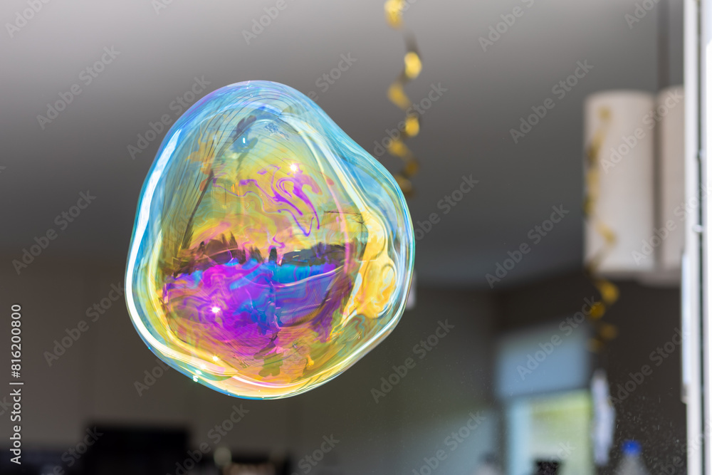 Фотография A colourful soap bubble floating in mid-air
