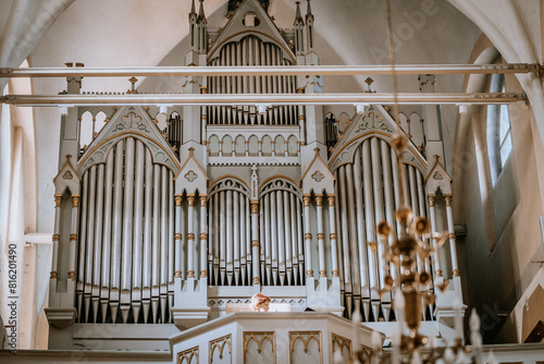Valmiera, Latvia - May 12, 2024 - a large church organ with ornate pipes and gothic architectural elements.