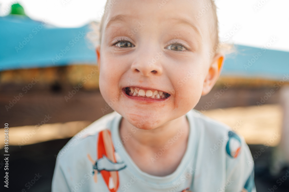 Close up of an adorable little boy smiling at the camera. Close up of an adorable little boy smiling at the camera.