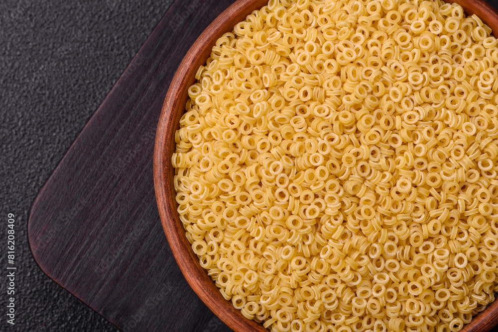 Raw anellini pasta from durum wheat with salt and spices Raw anellini pasta from durum wheat with salt and spices