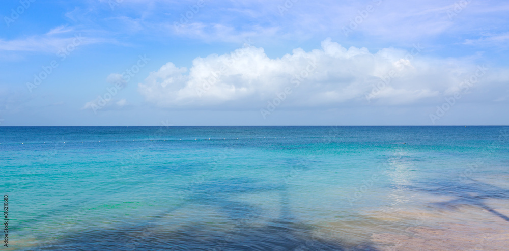Obraz premium Tropical paradise beach with white sand and blue sky.