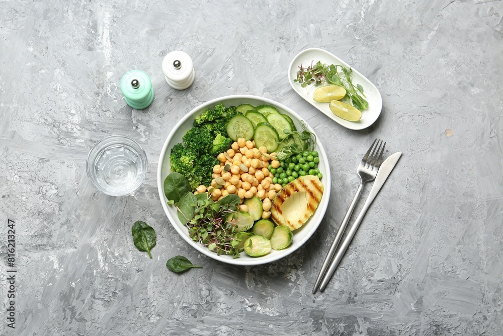 Healthy meal. Tasty vegetables and chickpeas in bowl on grey table, flat lay Healthy meal. Tasty vegetables and chickpeas in bowl on grey table, flat lay