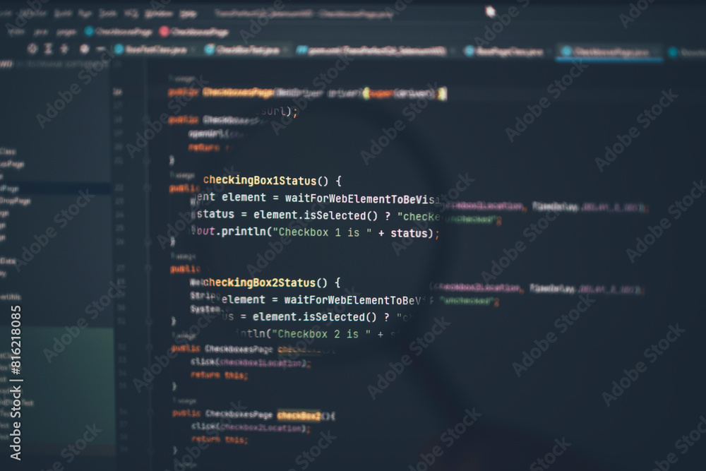 Close up of computer code under magnifying glass on computer screen. Close up of computer code under magnifying glass on computer screen.