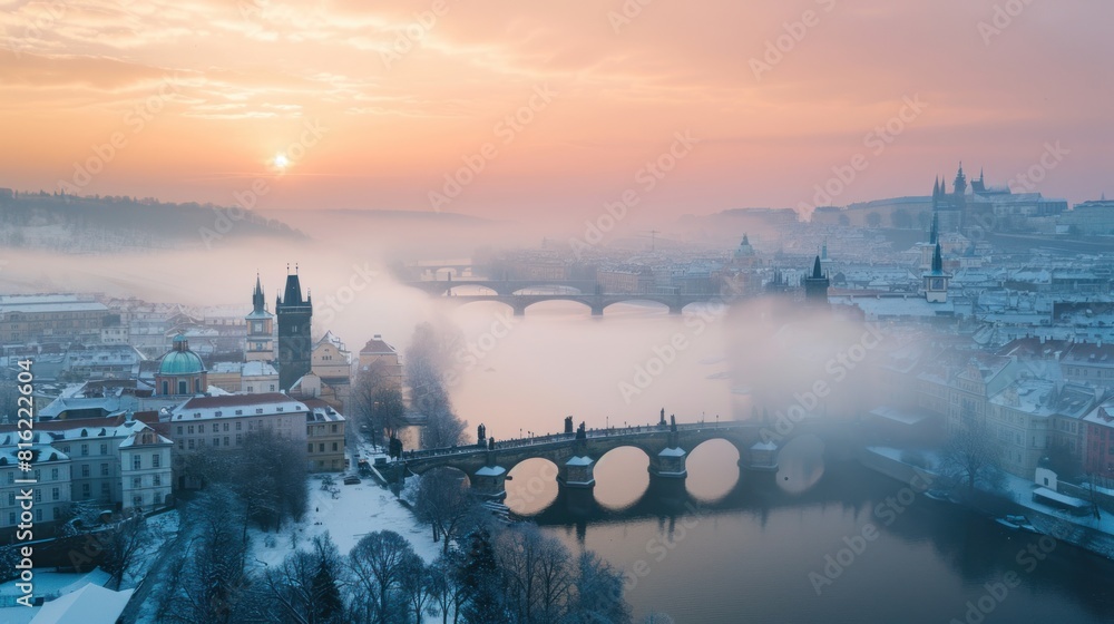 Fototapeta premium Charles bridghe with beautiful historical buildings at sunrise in winter in Prague city in Czech Republic in Europe.