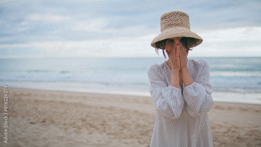 Happy lady posing coast on cloudy day closeup. Carefree smiling traveler walking