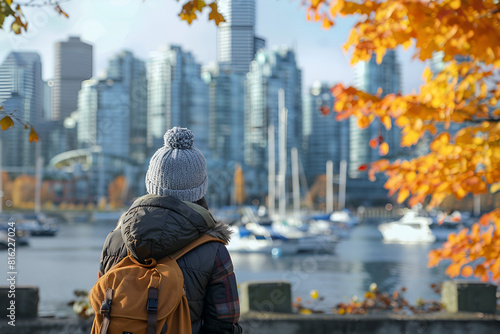 Vancouver city urban lifestyle people at Harbor, British Columbia. Woman tourist with student backpack in city outdoors enjoying autumn season.