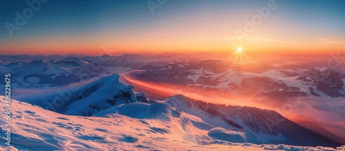 Majestic sun rising over snow covered mountain