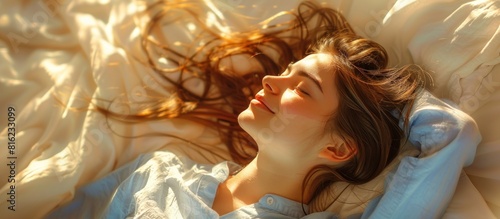 A woman with flowing hair, lying in bed with wind blowing through her hair, creating a serene moment.