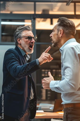 Angry office boss shouting, arguing and threatening his employee. Anger management concept.