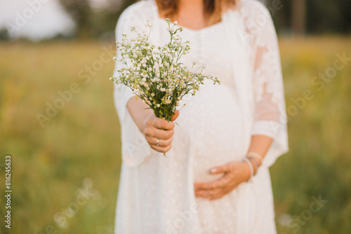 Pregnant woman outdoors photo