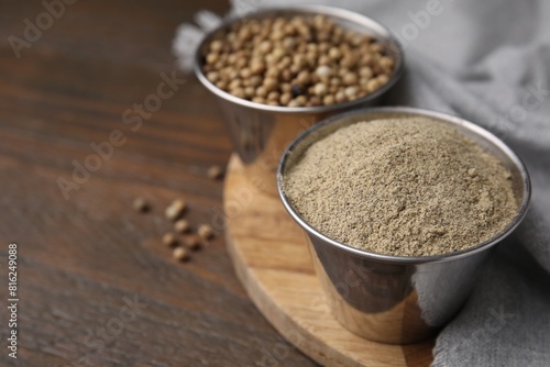 Ground pepper and peppercorns on wooden table, closeup. Space for text © New Africa