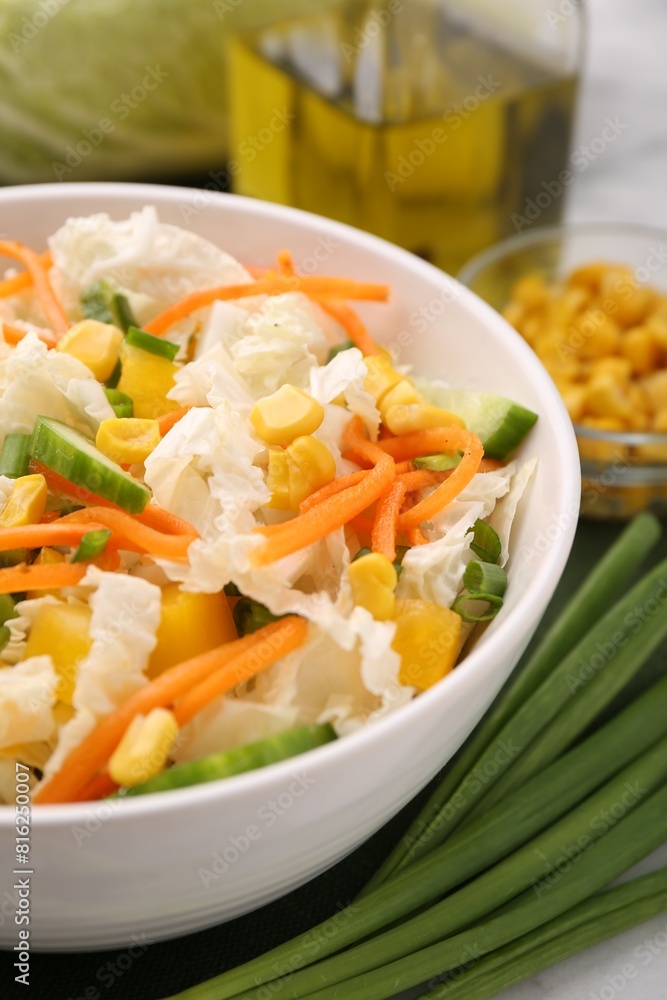 Tasty salad with Chinese cabbage, carrot, corn, cucumber and green onion on table, closeup Tasty salad with Chinese cabbage, carrot, corn, cucumber and green onion on table, closeup