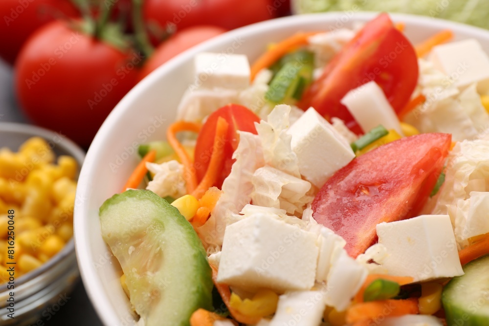 Tasty salad with Chinese cabbage, carrot, cheese, cucumber and tomato on table, closeup Tasty salad with Chinese cabbage, carrot, cheese, cucumber and tomato on table, closeup