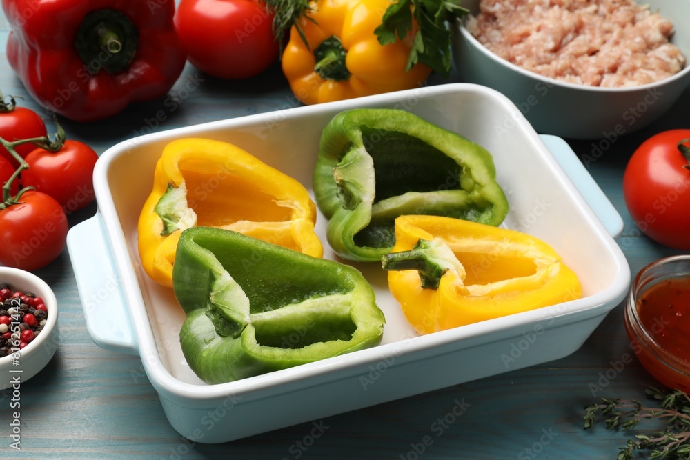 Making stuffed peppers. Vegetables and ground meat on light blue wooden table Making stuffed peppers. Vegetables and ground meat on light blue wooden table