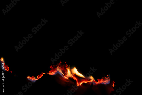 Obraz na płótnie burning paper, glowing edge of paper on a black background.