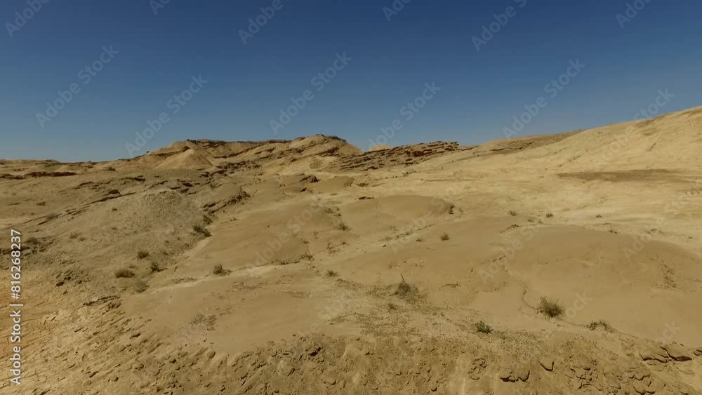 a rocky hill, capturing the unique patterns and textures of the rocks in the vast arid landscape under a sunny blue sky. a rocky hill, capturing the unique patterns and textures of the rocks in the vast arid landscape under a sunny blue sky.