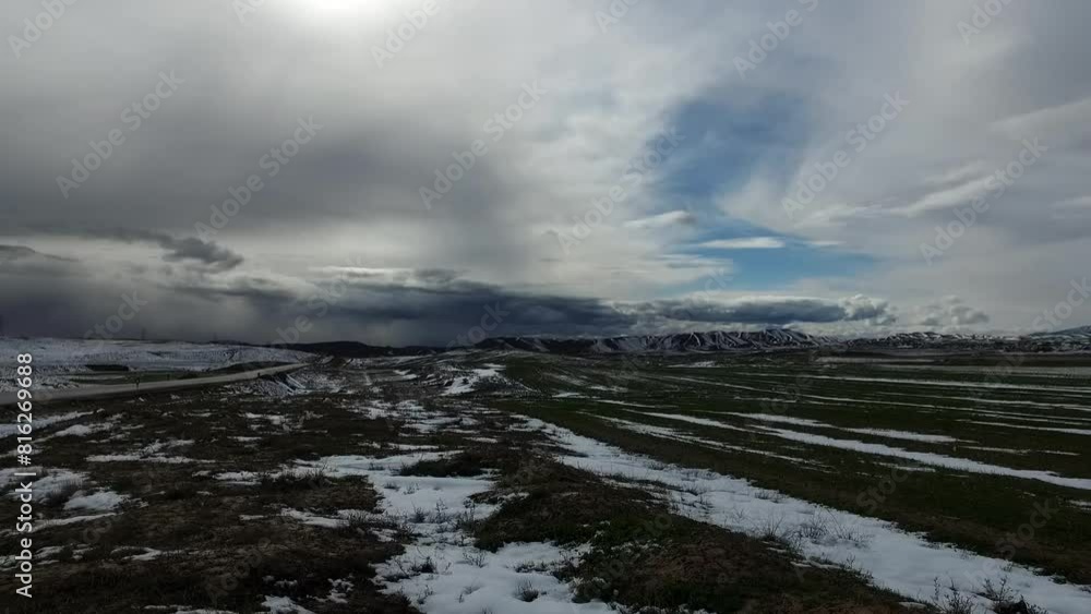 majestic winter landscape with snow capped mountains in the distance and a glimpse of distant traffic, conveying. majestic winter landscape with snow capped mountains in the distance and a glimpse of distant traffic, conveying.