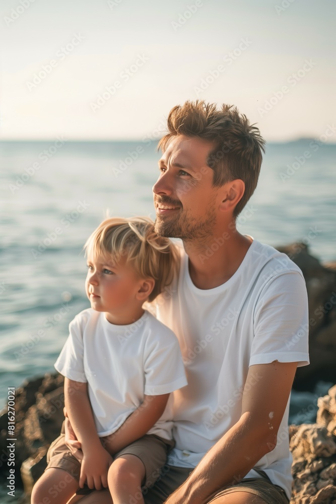 portrait of father and child sitting by sea on beach, family vacation concept, togetherness of parents and kids portrait of father and child sitting by sea on beach, family vacation concept, togetherness of parents and kids