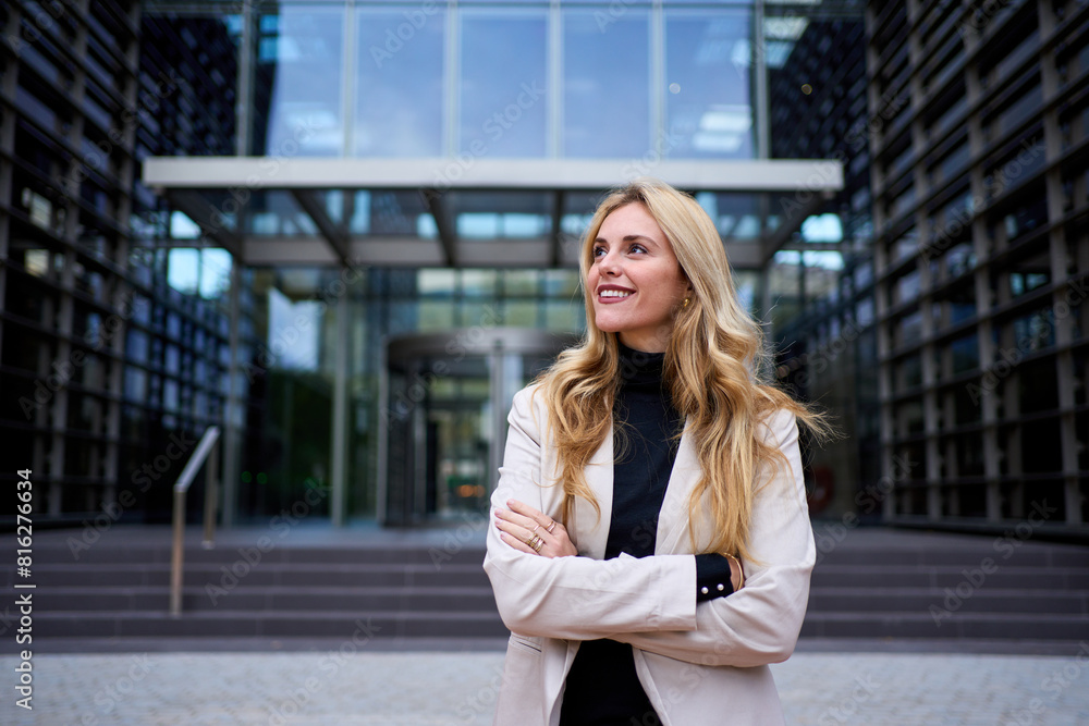Modern stylish Caucasian adult business woman dressed in formal suit standing in work place outdoor. Strong and empowered female happy with shaved head looking smiling to the side. Copy space Modern stylish Caucasian adult business woman dressed in formal suit standing in work place outdoor. Strong and empowered female happy with shaved head looking smiling to the side. Copy space