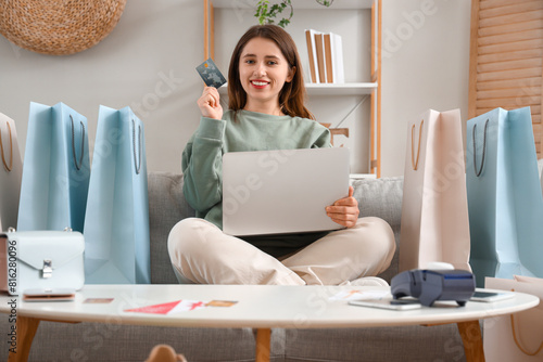 Young woman with laptop sho...