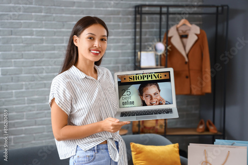 Young Asian woman with lapt...