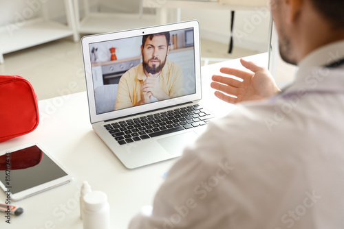 Male doctor video chatting ...