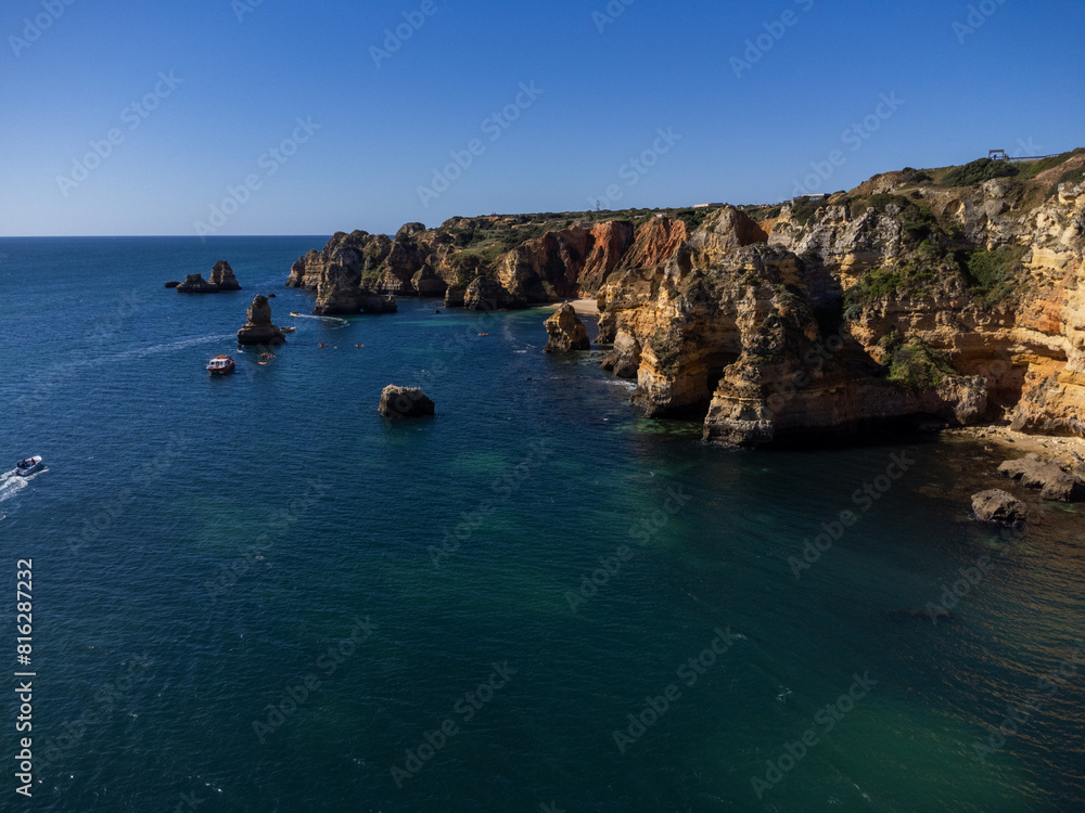 Fototapeta premium Praia de Dona Ana beach near Lagos town, Algarve, Portugal. Praia Dona Ana beach with turquoise sea water and cliffs, Portugal. Drone aerial view