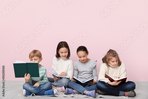 Little children reading boo...