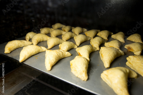 Photograph of empanadas baking. 