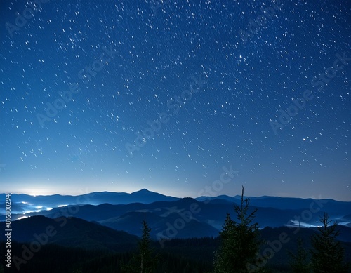 a night sky filled with stars and a mountain range in the distance.