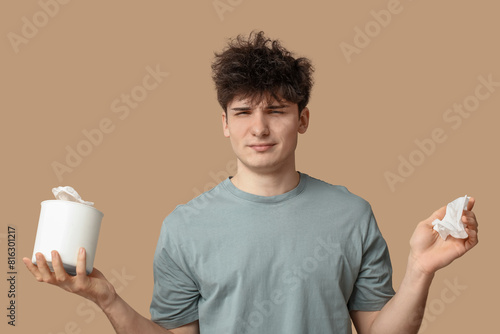 Young man with tissues on b...