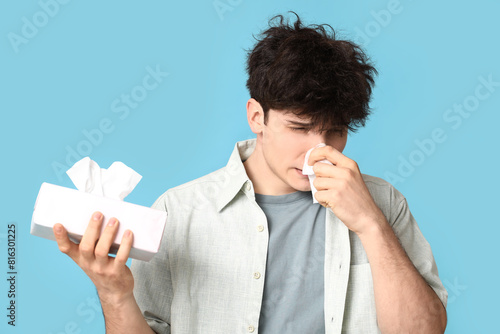 Young man with runny nose o...
