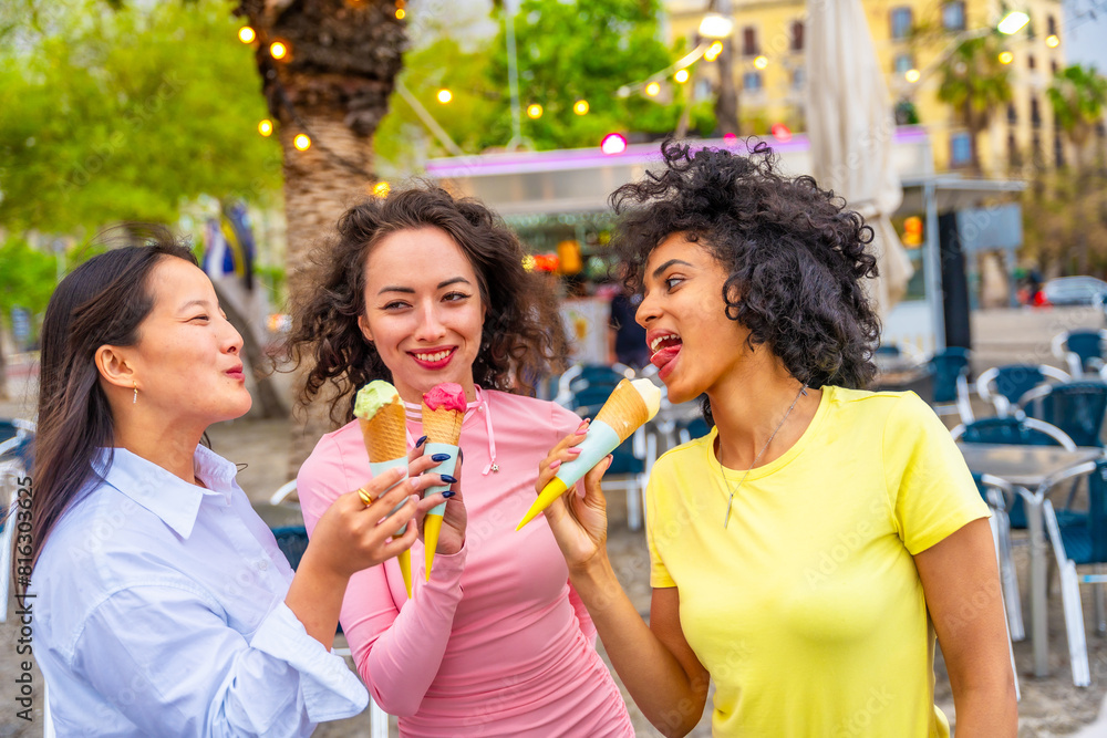 Friends eating ice cream enjoying summer in the city Friends eating ice cream enjoying summer in the city
