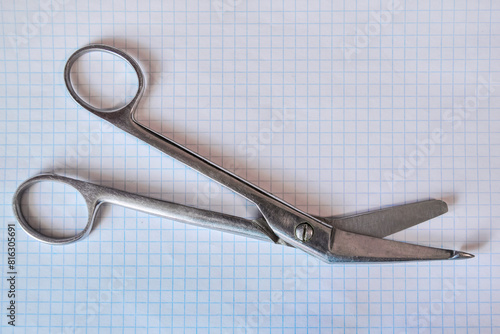 Bandage scissors on white background, top view.